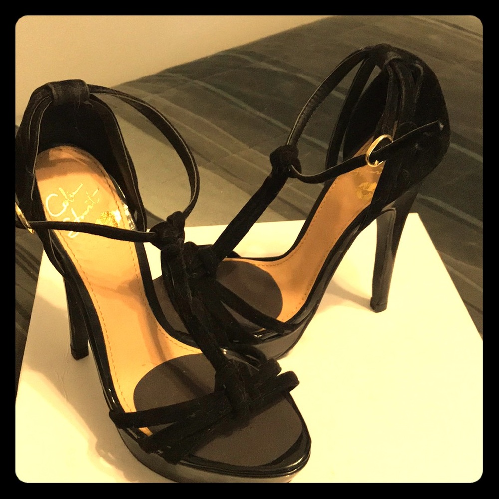 High heeled, black scrappy sandal.